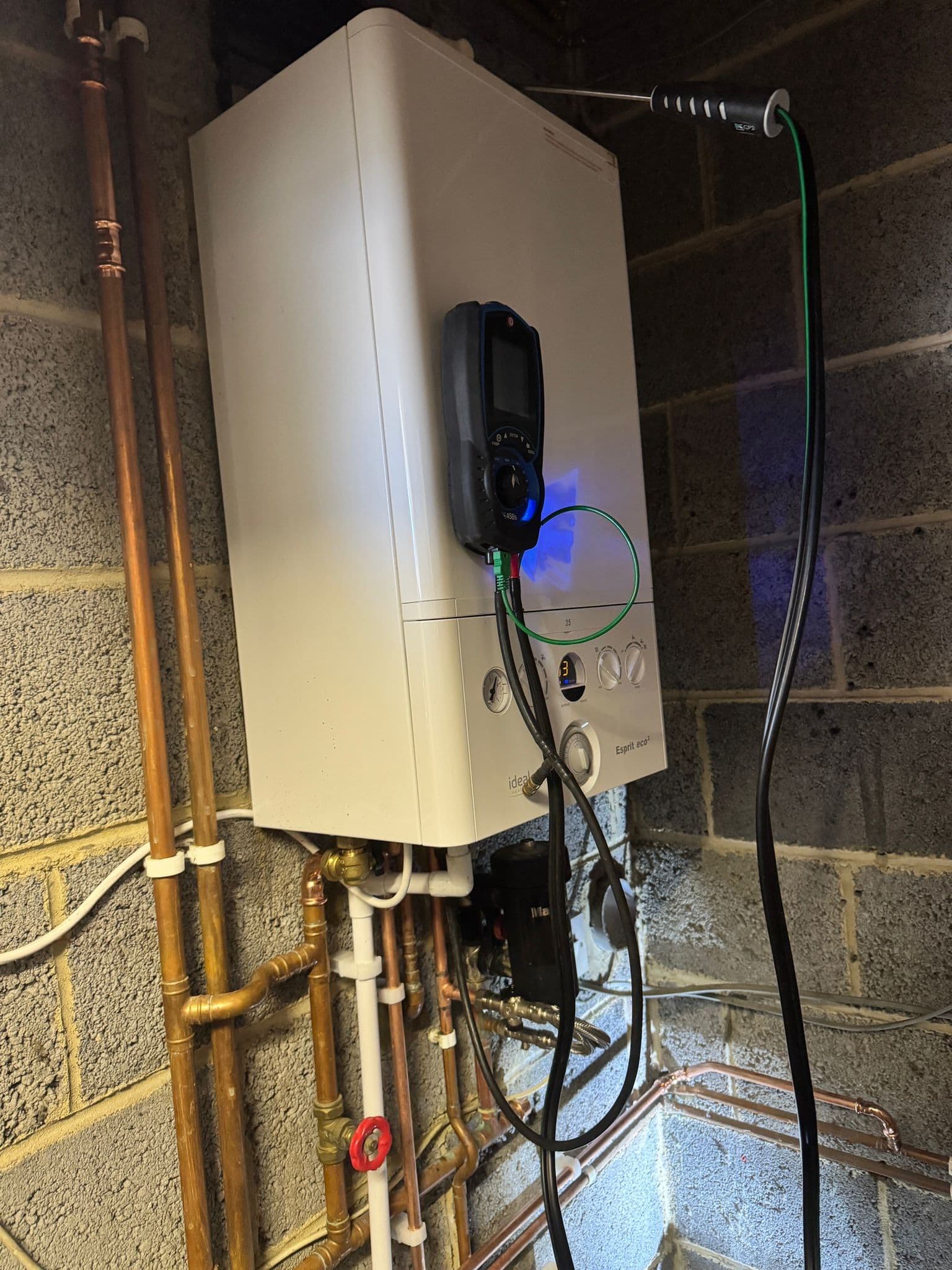 New Ideal combi boiler being commissioned with a flue gas analyser after a system-to-combi conversion