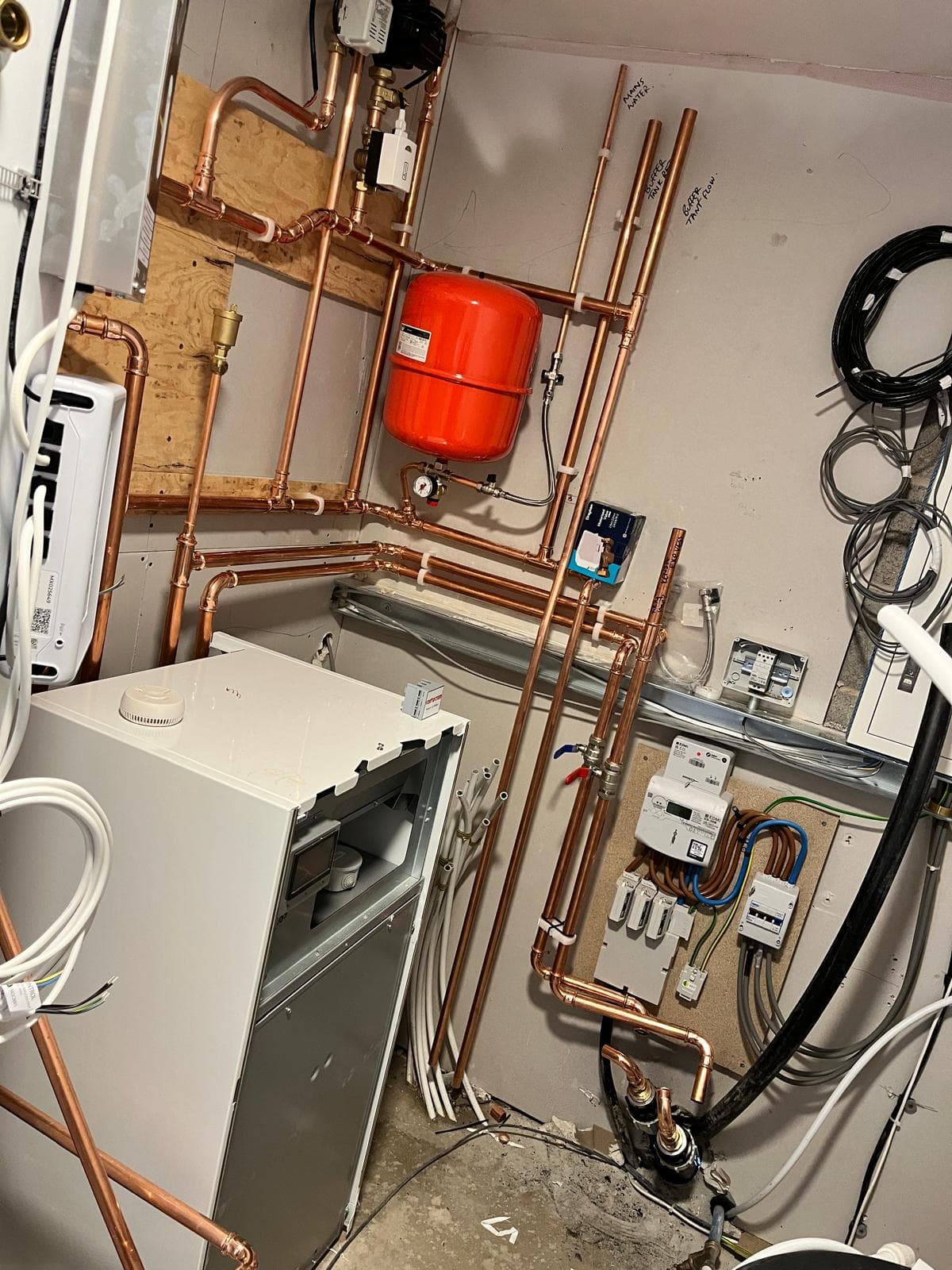 Indoor ground source heat pump plant room with the heat pump, fully soldered copper pipework, expansion vessel and system controls