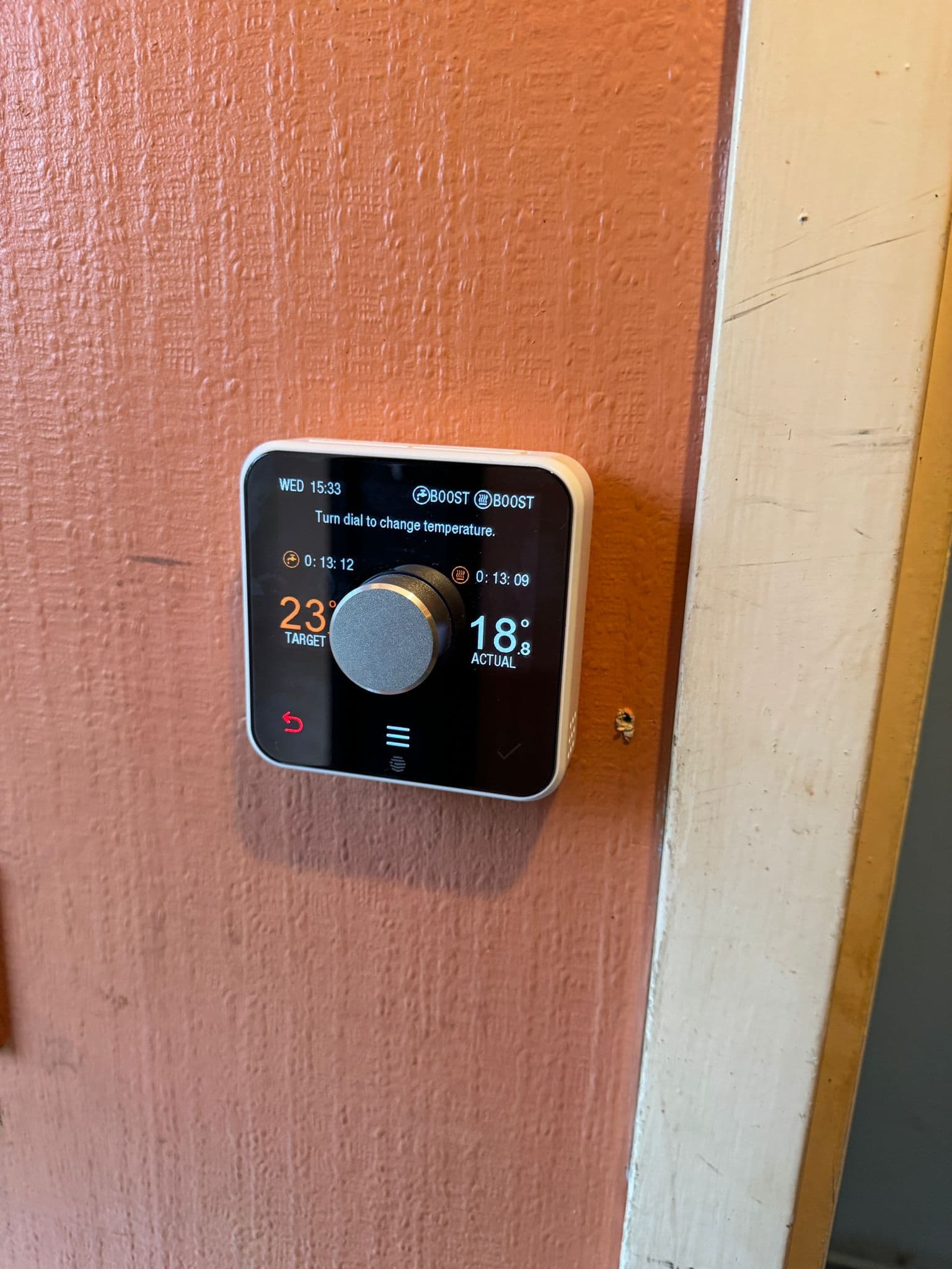 Hive smart thermostat installed on a wall showing a 23 degree target temperature
