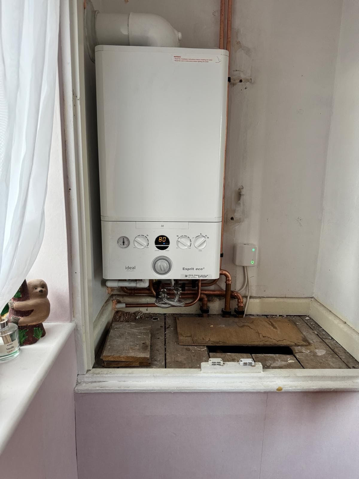 Ideal Esprit Eco2 combi boiler installed in a tight alcove with neat copper pipework