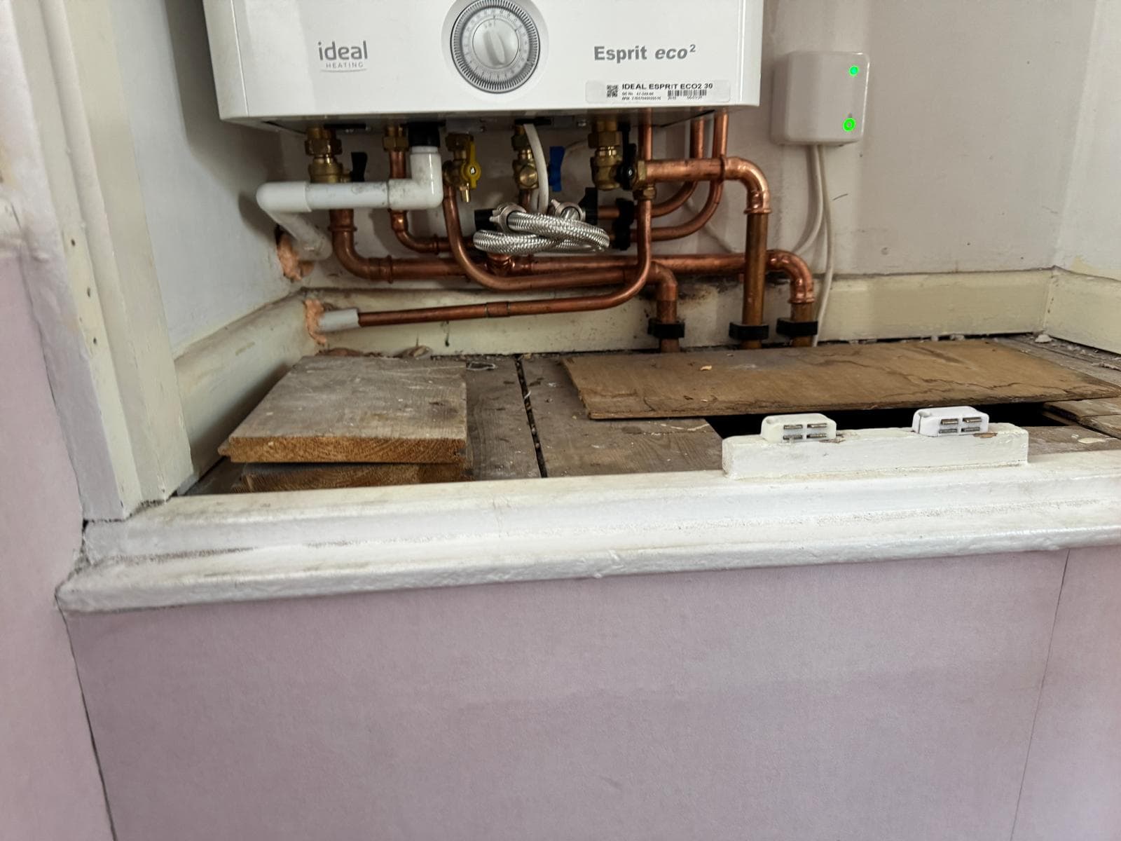 Close-up of the valves and copper pipework beneath the Ideal Esprit combi boiler
