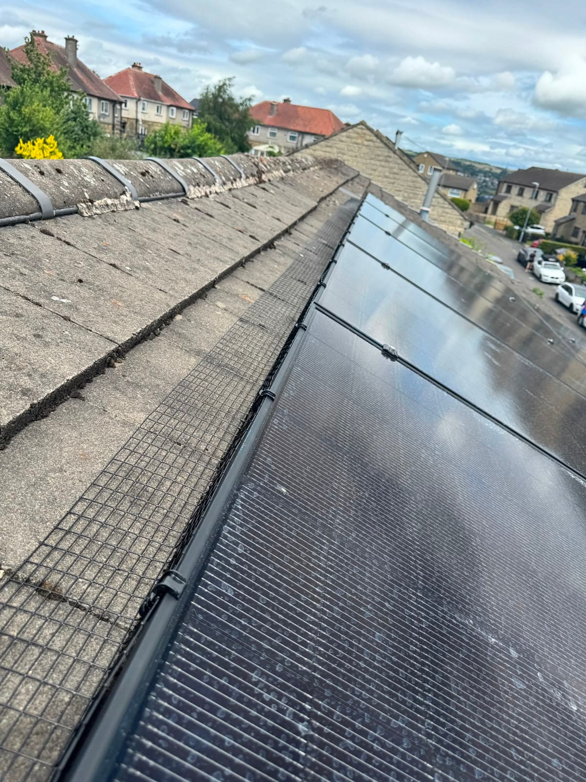 Roof ridge cable routing and bird-proof mesh on the solar panel edge